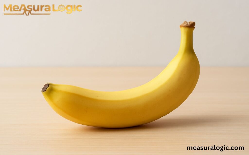 Medium ripe banana showing approximately 6 inches length as a visual size reference.