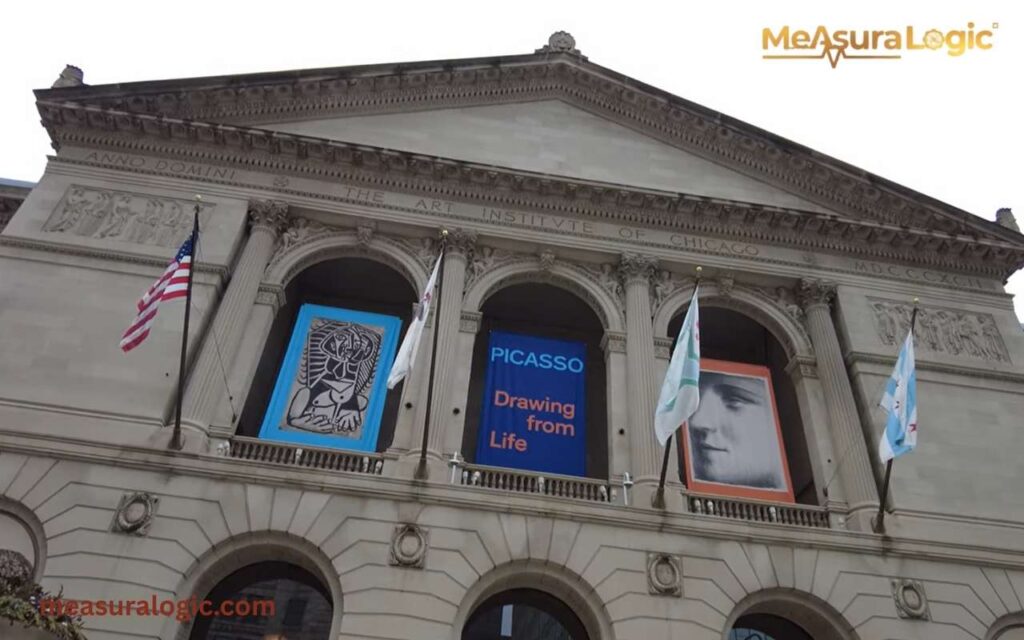 The grand Neoclassical facade of the Art Institute of Chicago featuring arched entrances and banners for a Picasso exhibition.