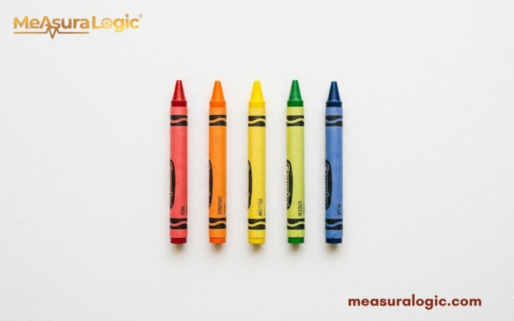 Five colorful crayons standing in a neat row. On a plain white background.