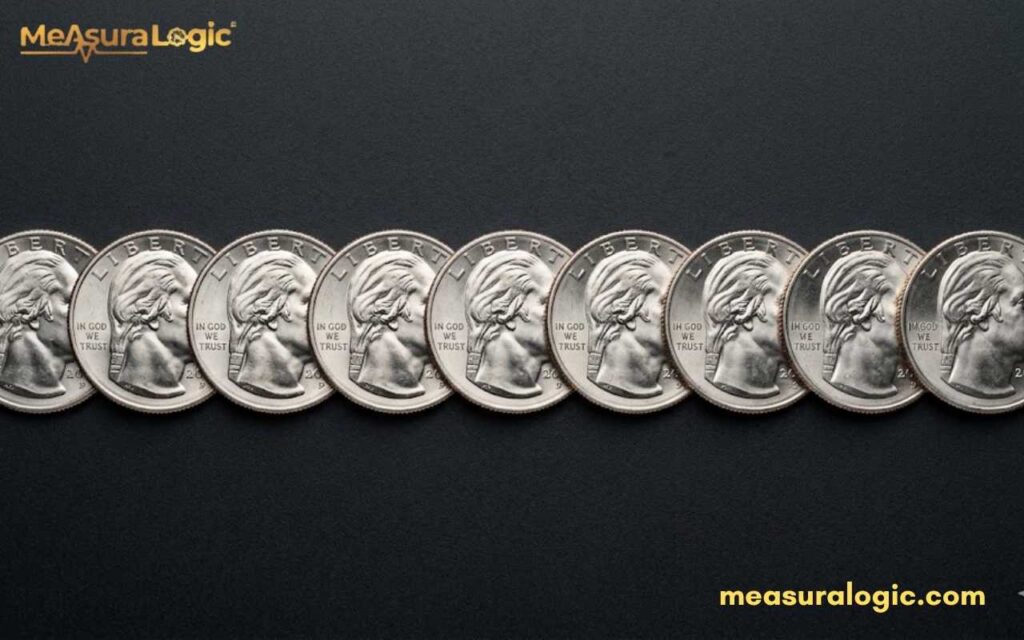 Nine US quarters are arranged in a horizontal row on a black textured surface.