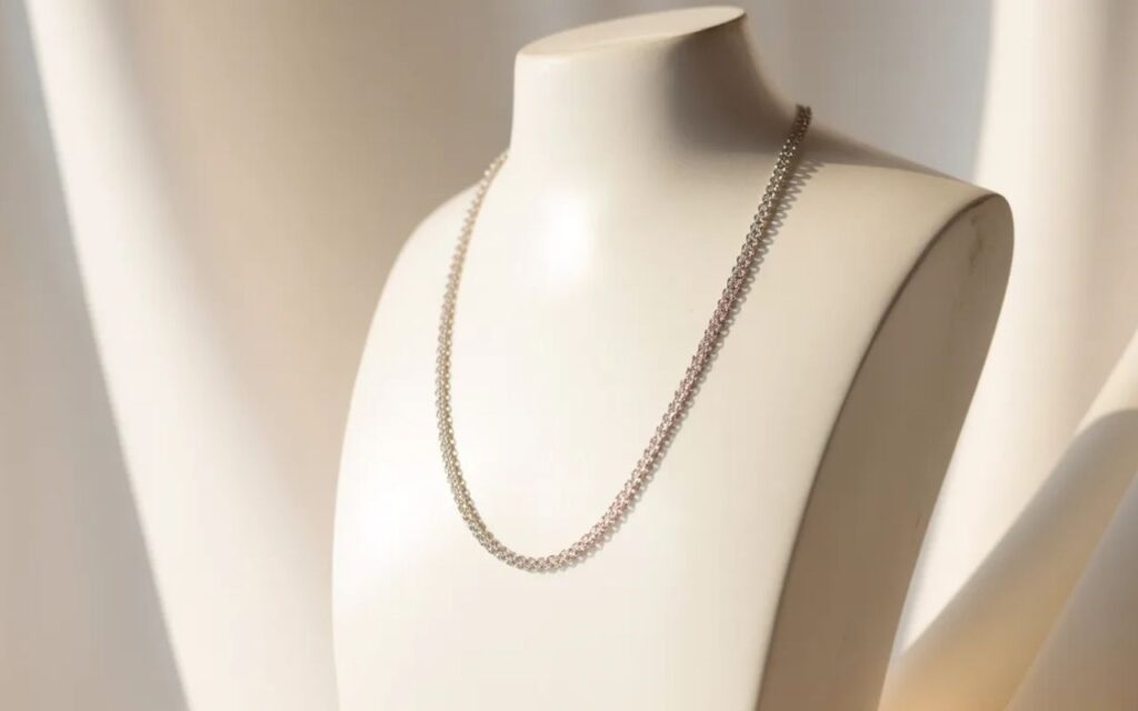 18 inches necklace displayed on a mannequin bust, elegant minimal background, soft lighting, jewelry focused composition.