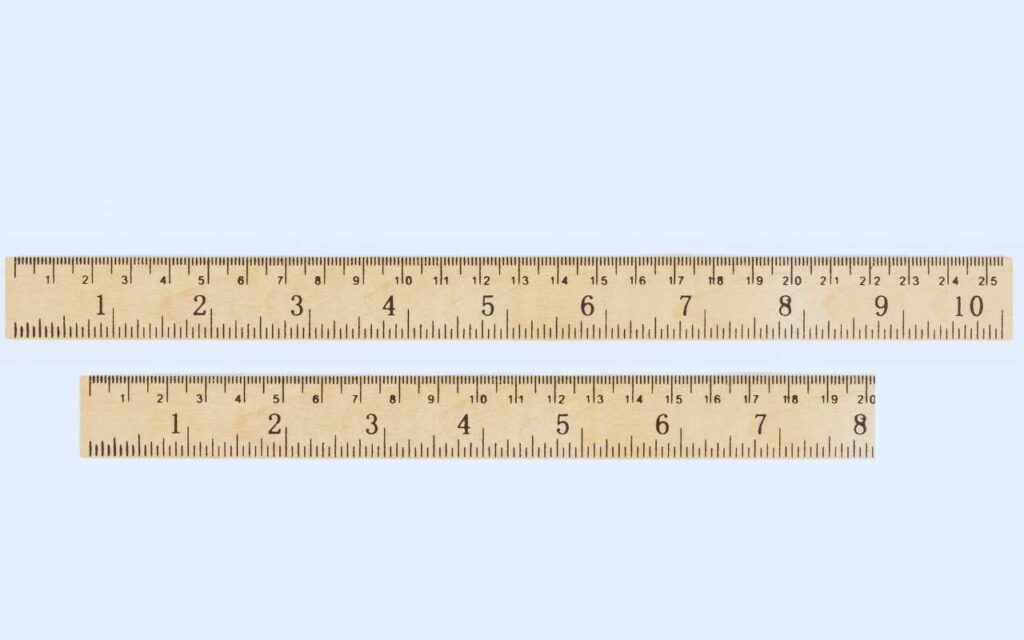 Two wooden rulers showing both metric and imperial scales. The top ruler displays a length of 10 inches, while the shorter bottom ruler measures 8 inches.