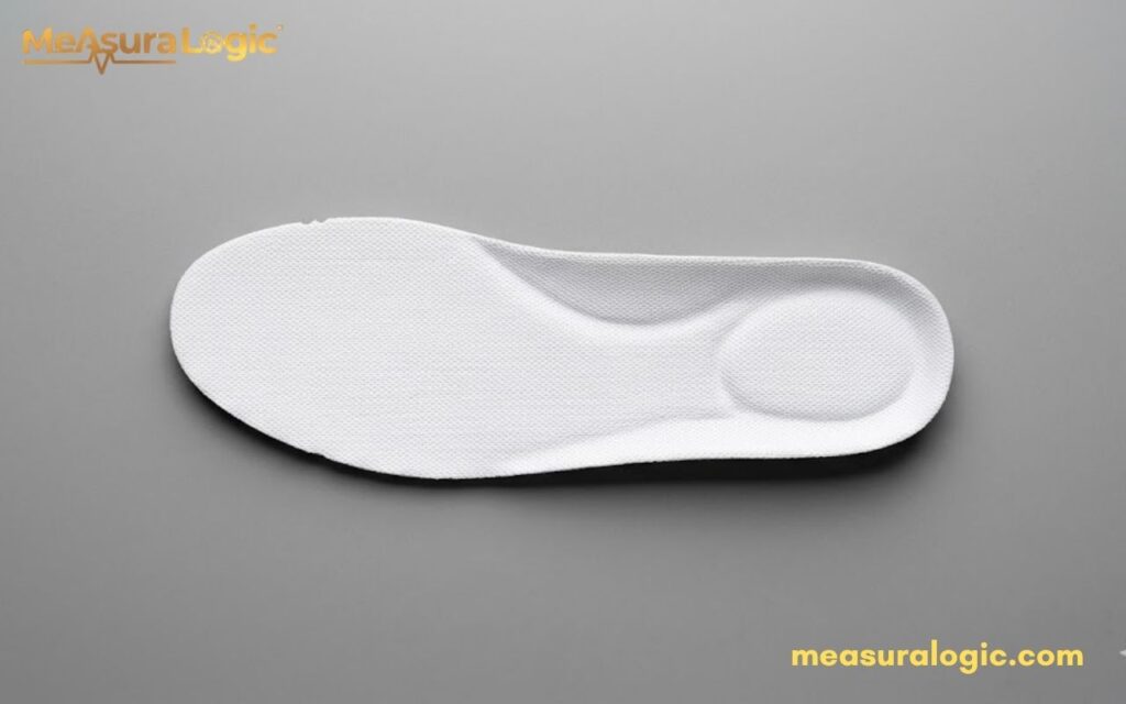 A single white 9 inches shoe insole with molded arch support. Viewed from above on a neutral grey background.