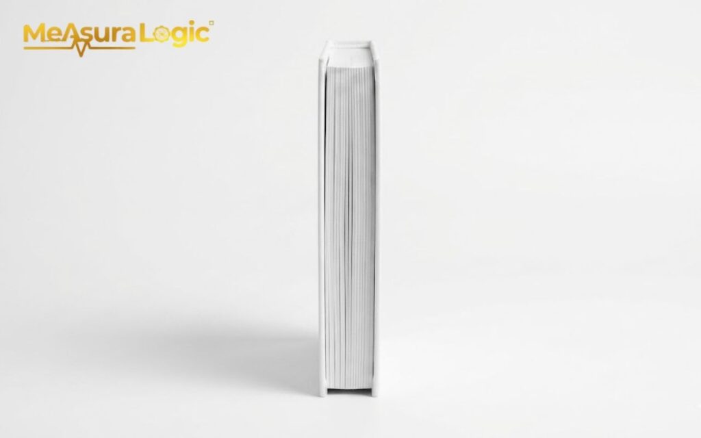 Upright closed white book. Blank spine on white.